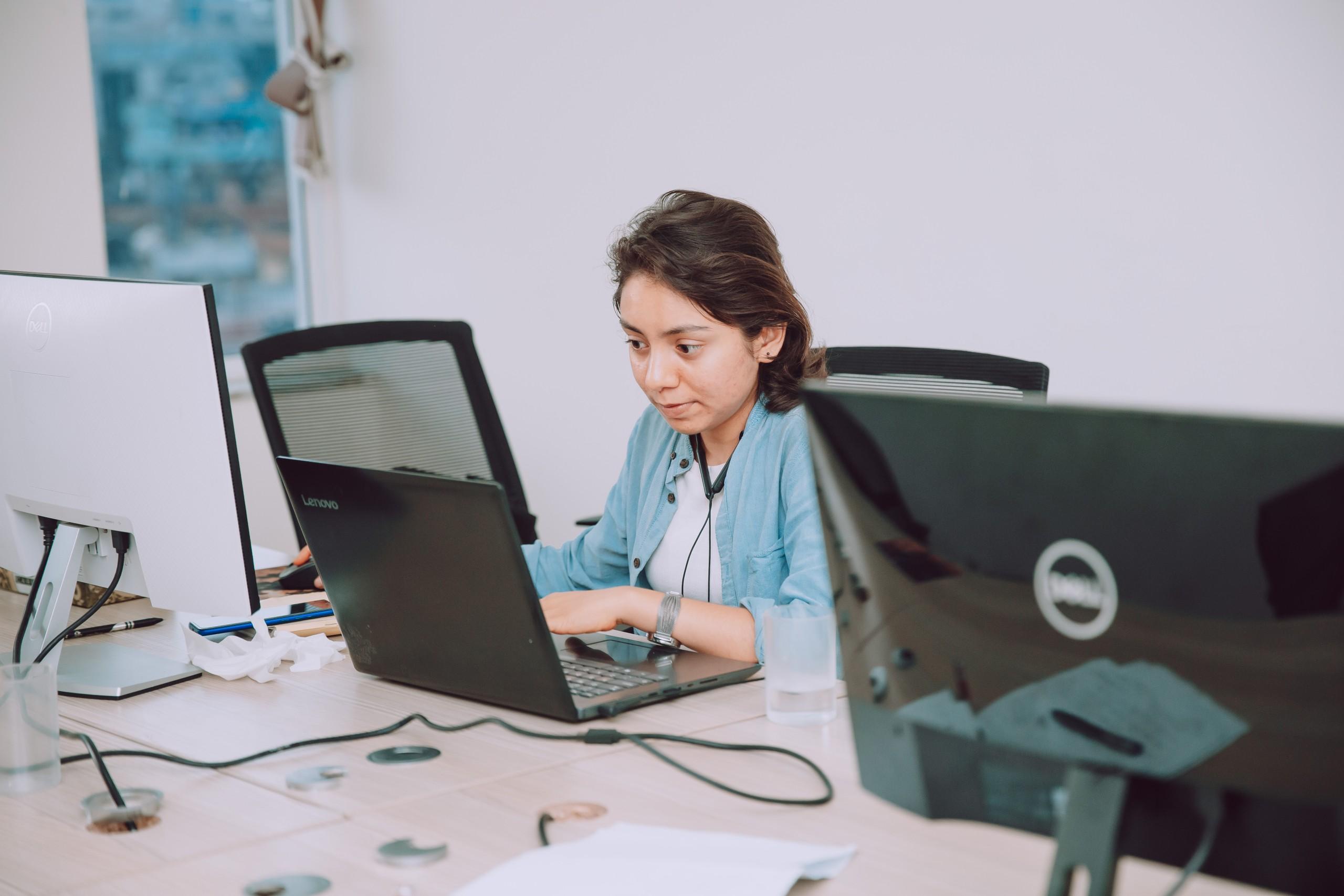 a girl working infront of her laptop in 